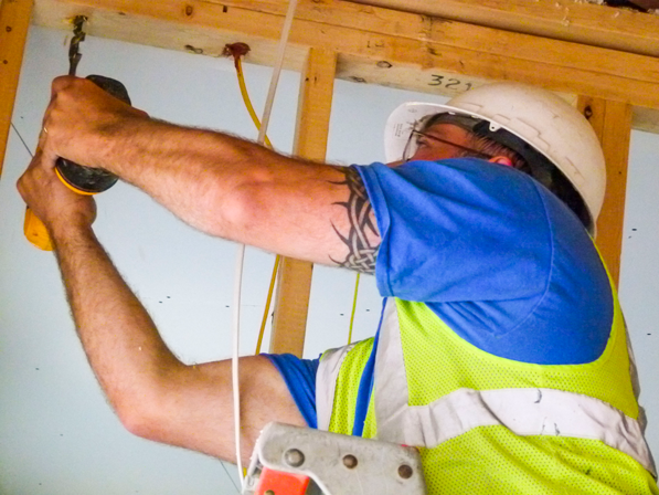 Employee wiring up a house.